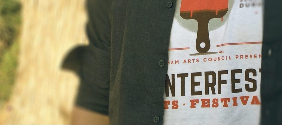 A person wearing a CenterFest Arts Festival t-shirt