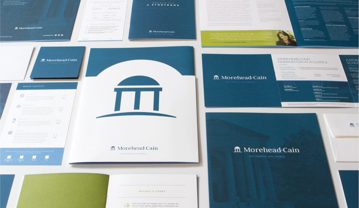 The Morehead-Cain Scholarship print designs layed out on a table