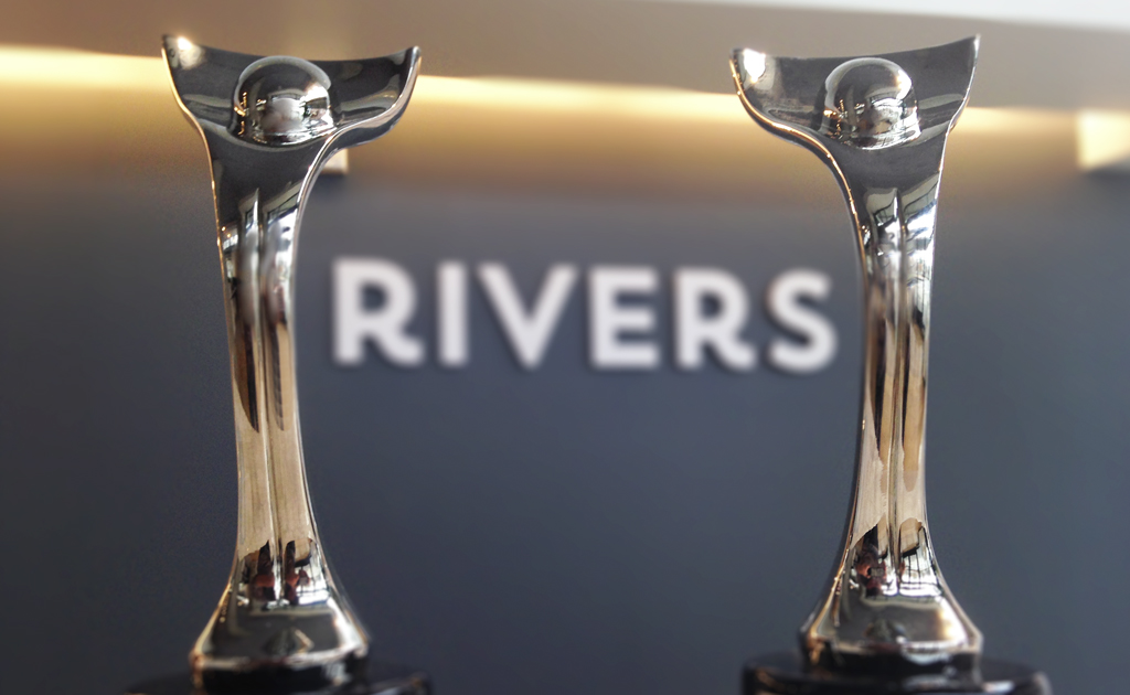 rivers logo between two davey award trophies