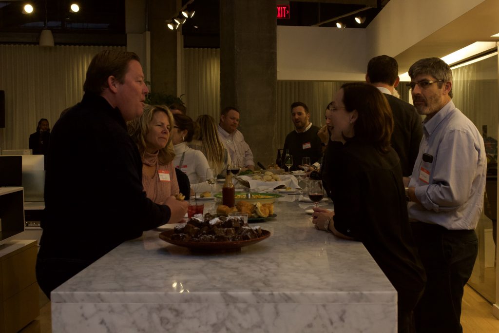 Attendees eating and talking at FUN-raiser at Rivers Agency